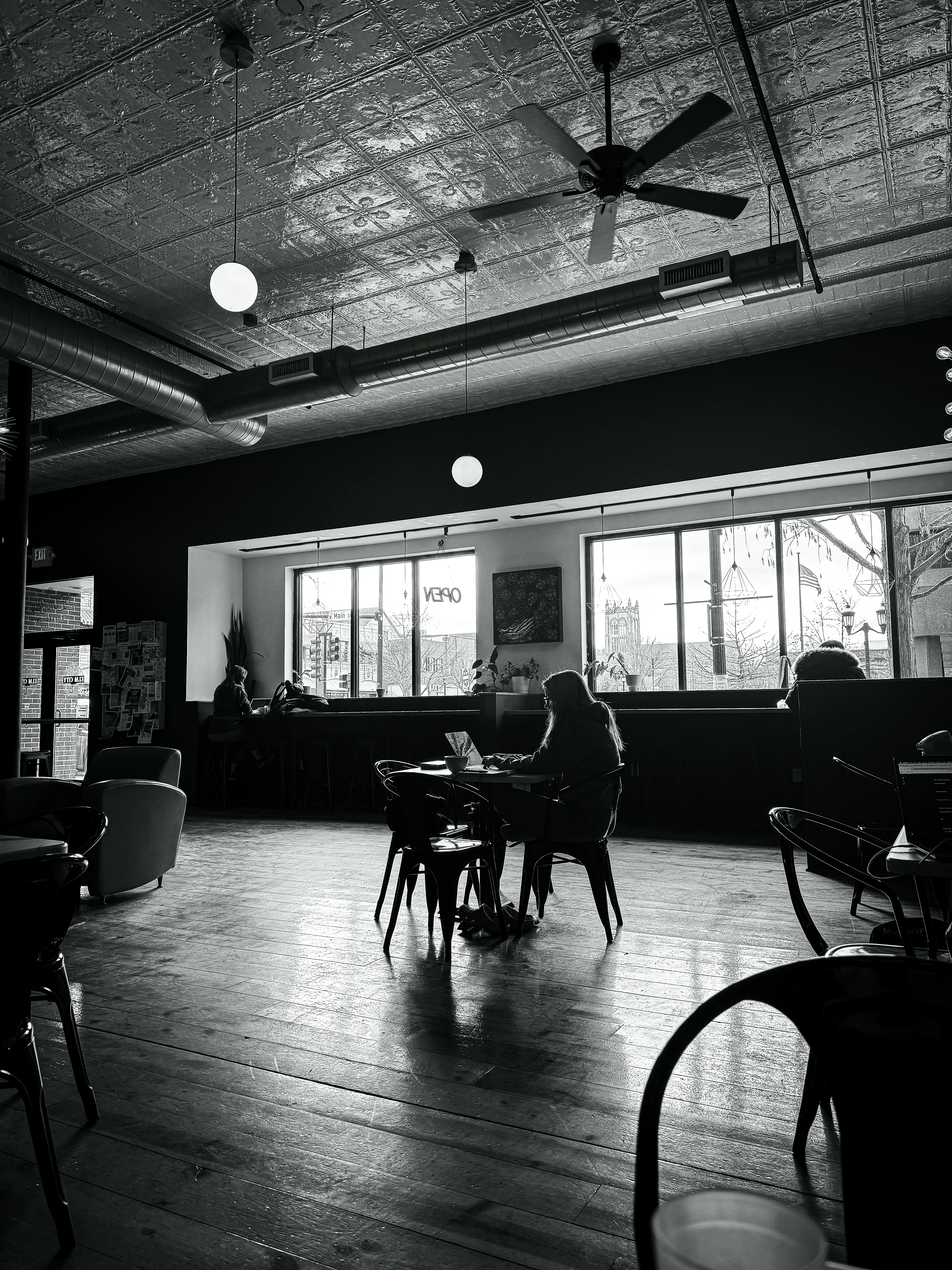 Brand & location — café interior, tin ceiling, atmospheric monochrome