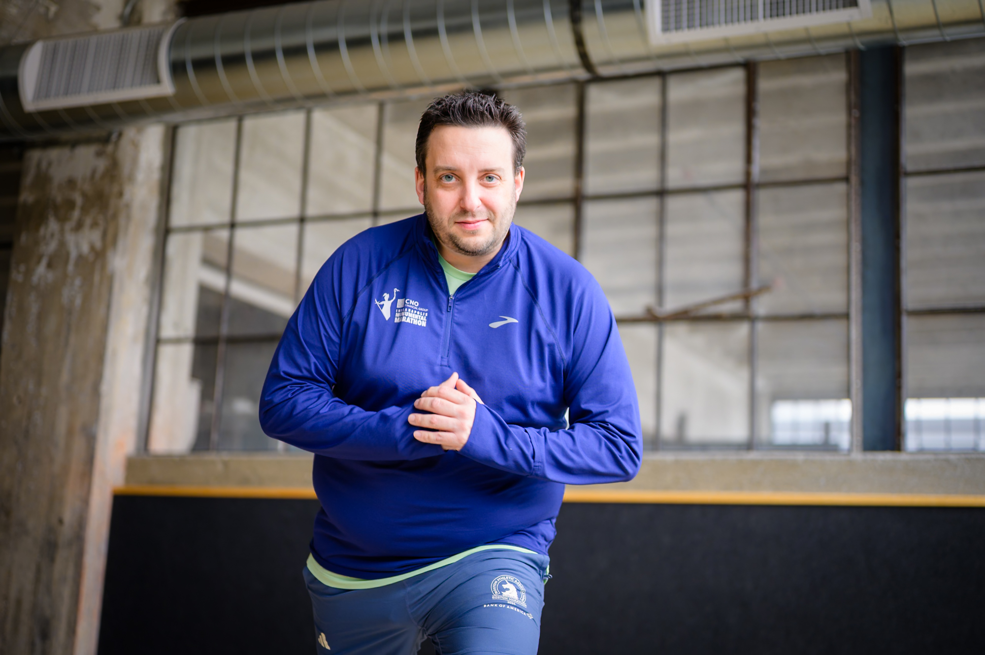 Portrait — man in blue jacket, industrial space