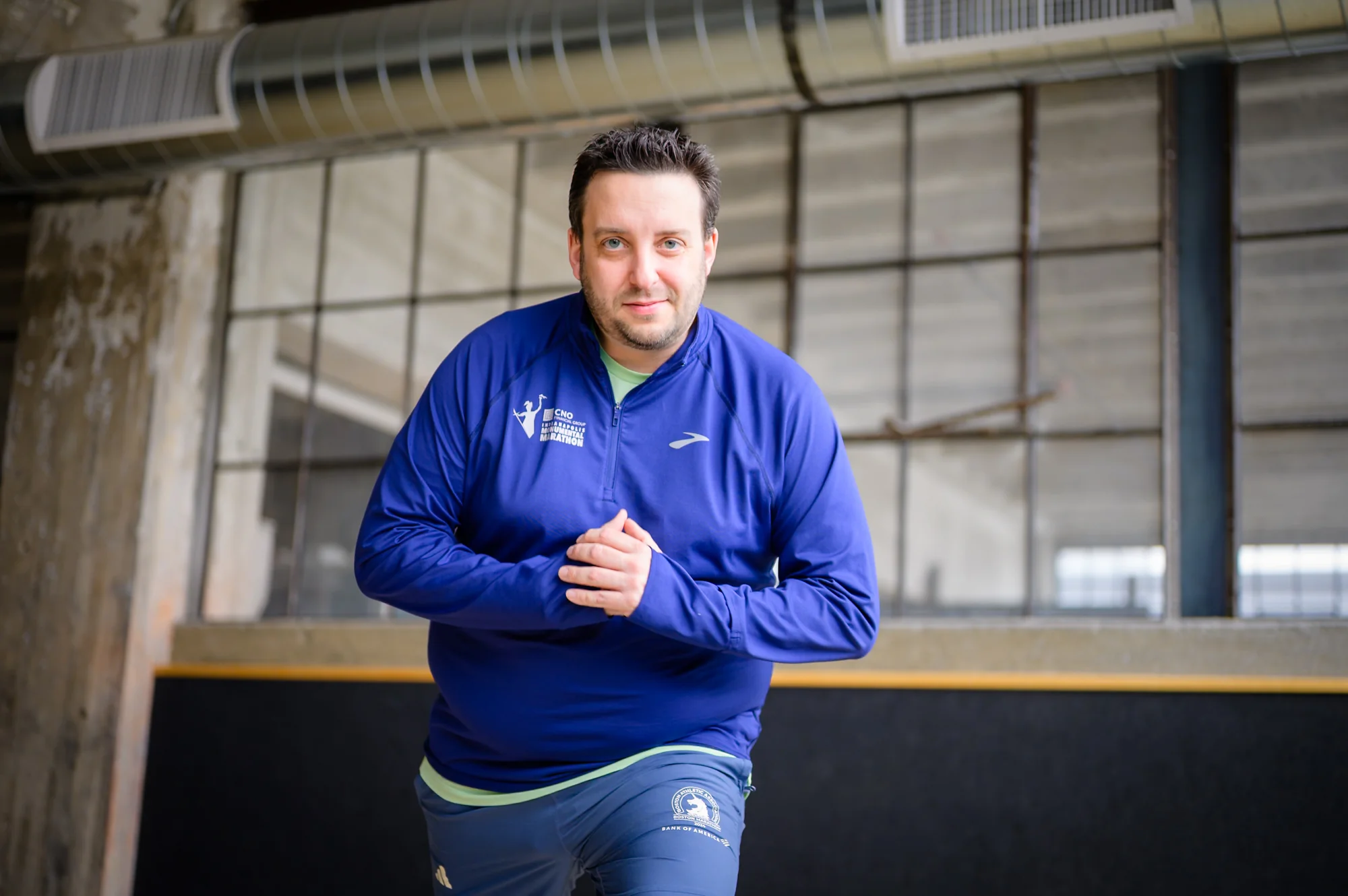 Portrait — man in blue jacket, industrial space