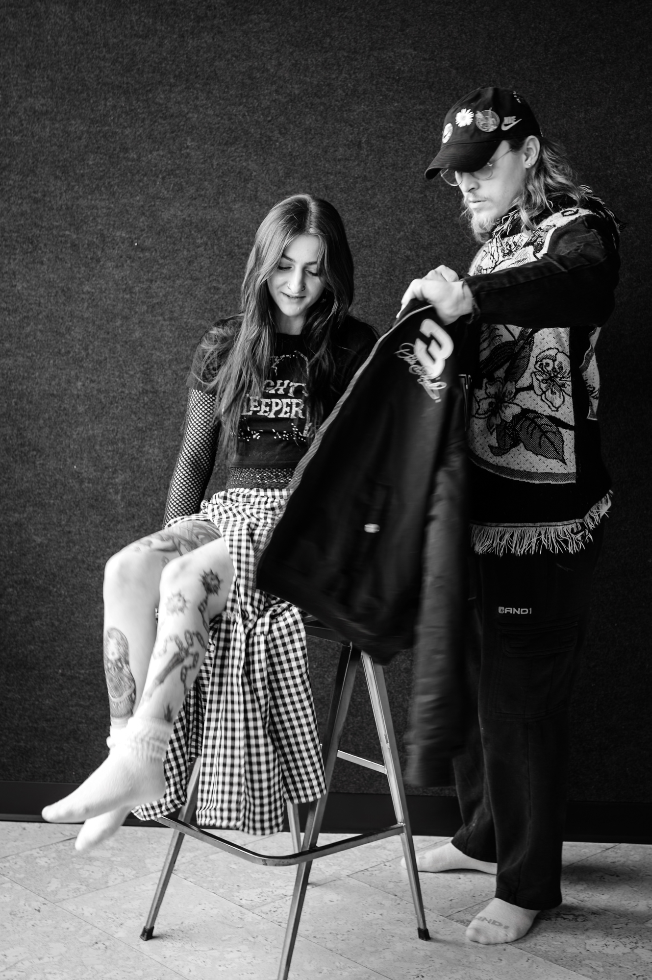 Portrait — two people in studio, one seated, one standing